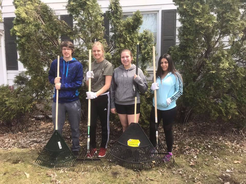 Students with garden rakes.