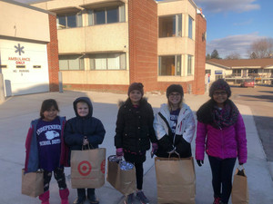 elementary students with gifts in bags